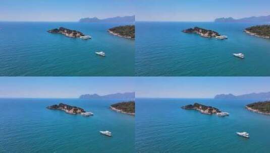 无人机用游船射击无尽的大海，小岛和山脉。高清在线视频素材下载