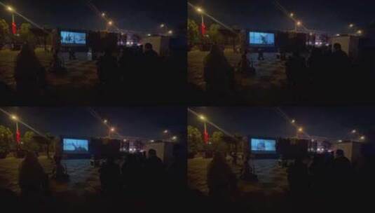 夜晚广场看幕布电影的居民1高清在线视频素材下载