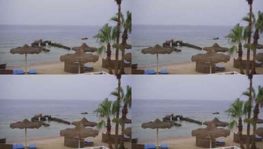 天空海滩度假村带椅子和桌子的阳伞高清在线视频素材下载