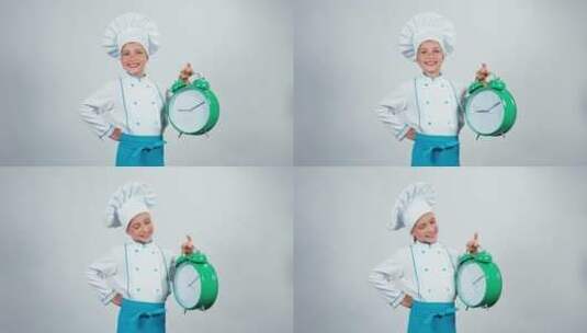 穿厨师服的小女孩拿着闹钟高清在线视频素材下载