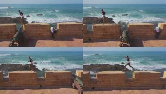 在摩洛哥索维拉古城一名男子沿着城墙奔跑高清在线视频素材下载
