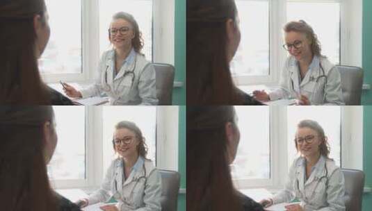 女医生微笑着聆听病人的讲话高清在线视频素材下载