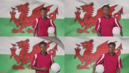 威尔士国旗前抱着足球的男人高清在线视频素材下载