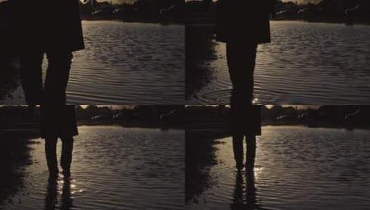 日落时在水中行走的人高清在线视频素材下载