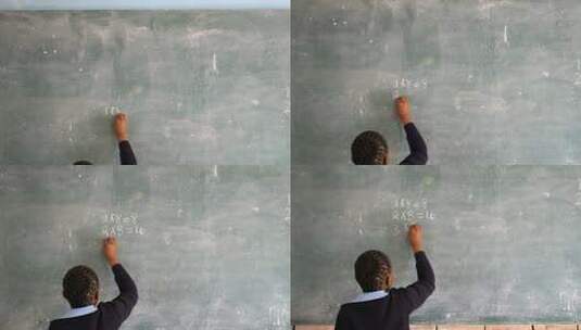 女学生在教室的黑板上写字高清在线视频素材下载