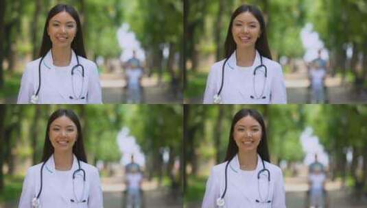开朗的女治疗师对着镜头微笑，在医院公园，高清在线视频素材下载