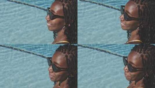 女人带着太阳镜在泳池中高清在线视频素材下载