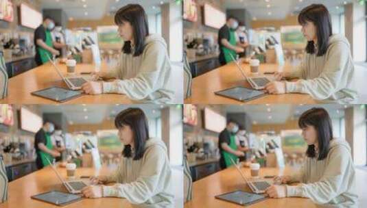 年轻女子在咖啡馆使用笔记本电脑高清在线视频素材下载