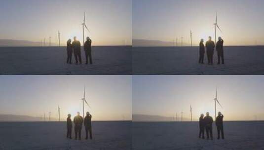 三个工人站在风力发电车前讨论展望高清在线视频素材下载