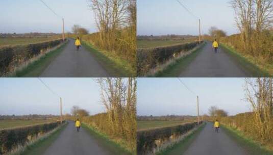 跟踪拍摄走在乡村公路上的人高清在线视频素材下载