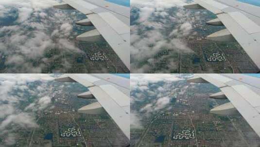 白天在城市上空飞行时，从飞机机翼的飞机窗口拍摄的风景。高清在线视频素材下载