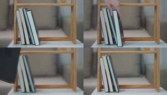 女人的手从木书架上拿了一本书高清在线视频素材下载