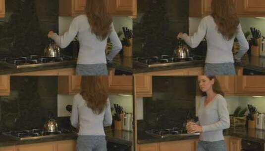 一个女人在厨房柜台边饮茶高清在线视频素材下载