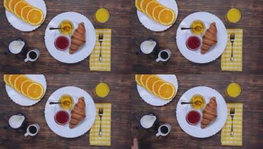 在餐桌上吃早餐_有面包_咖啡和水果高清在线视频素材下载