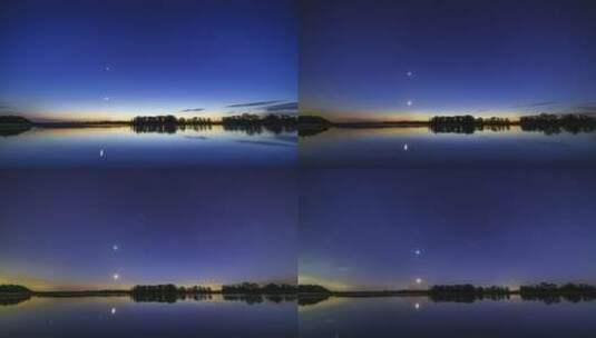 夜晚湖面倒影下美丽的蓝色布满行星的天空高清在线视频素材下载