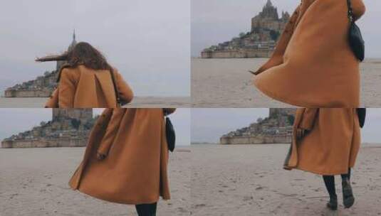 特写时尚快乐的旅游女人在史诗圣米歇尔山柔软的海沙上慢慢行走高清在线视频素材下载