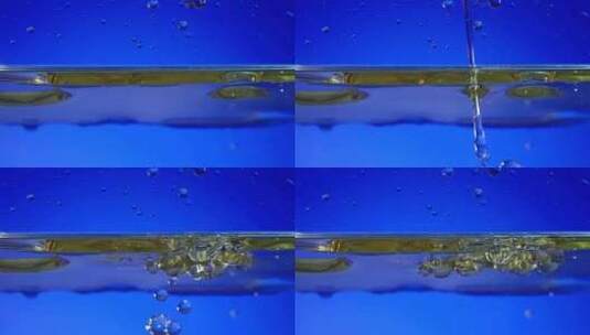 蓝色背景下工业油液体滴落高清在线视频素材下载