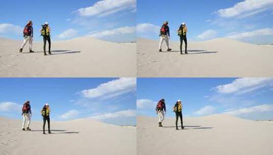 背着背包在沙漠中行走的情侣高清在线视频素材下载
