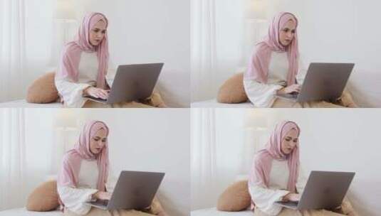 戴着粉色头巾的女人操作电脑高清在线视频素材下载