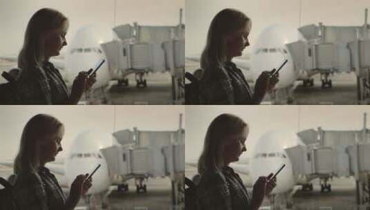 女孩在航站楼使用手机高清在线视频素材下载
