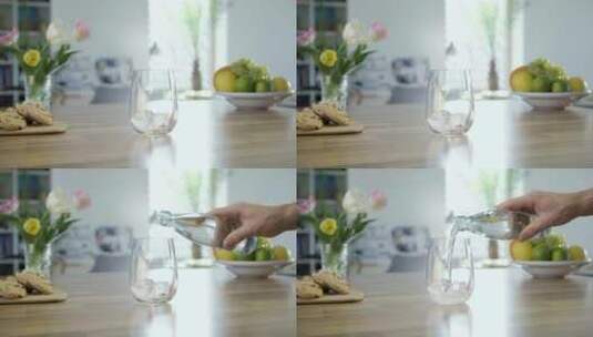 在厨房的桌子上往玻璃杯里倒一杯苏打水高清在线视频素材下载