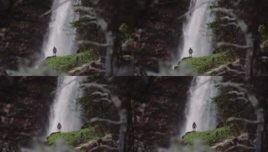 男人站在巨大的瀑布前高清在线视频素材下载