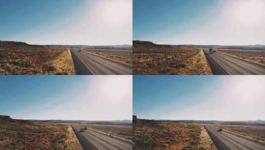 无人机在典型的美国沙漠公路乡村道路上低空飞行，汽车经过高清在线视频素材下载