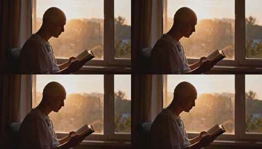 窗边老人阅读书籍画面高清在线视频素材下载