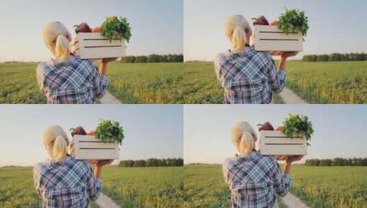 一个女农民用肩扛着一盒新鲜蔬菜高清在线视频素材下载
