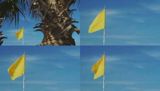 黄旗在蓝天的沙滩上随风飘扬高清在线视频素材下载