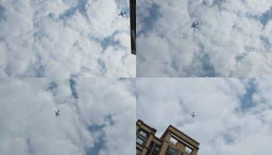 飞机飞过建筑上空高清在线视频素材下载