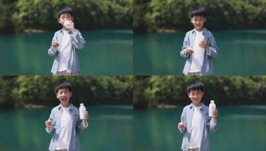 中国小男孩在户外喝有机牛奶高清在线视频素材下载
