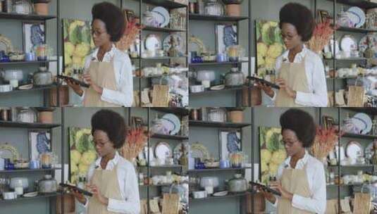 非洲发型迷人的女人在自己的手工礼品店计算高清在线视频素材下载