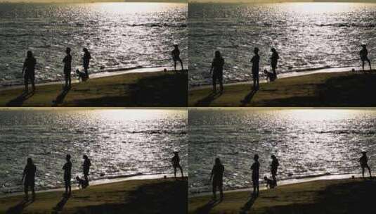 海南三亚黄昏阳光下沙滩度假的人群剪影高清在线视频素材下载