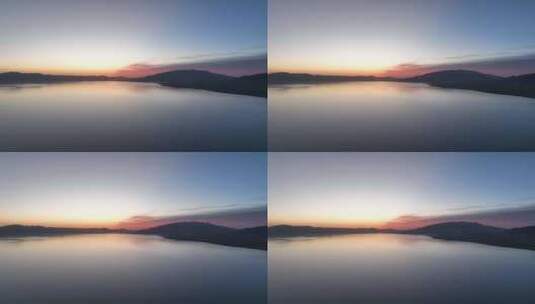 清晨朝霞倒映在赛里木湖平静的湖面航拍高清在线视频素材下载