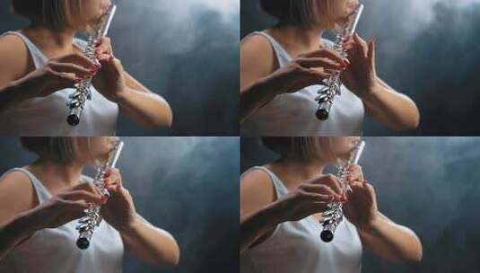 职业音乐家女性长笛演奏。烟雾工作室高清在线视频素材下载