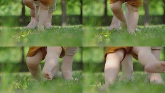 母亲陪伴孩子婴儿光脚在草地上走路！高清在线视频素材下载