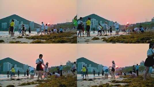 三亚大东海景区沐浴在夕阳余晖下的游客市民高清在线视频素材下载