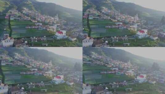 航拍山坡的上彩色房屋高清在线视频素材下载
