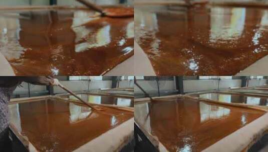 工业糖厂生产糖浆糖水均匀摊平晾晒凝固高清在线视频素材下载