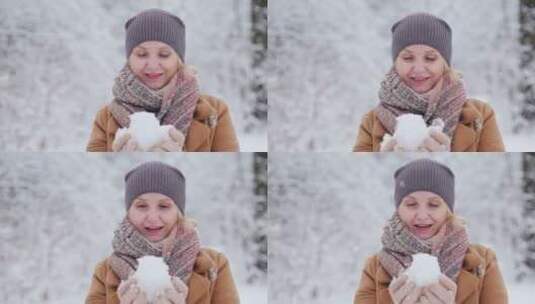 女人用双手把雪做成了雪球高清在线视频素材下载