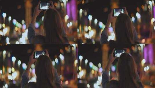 女人用手机拍摄城市夜晚美景高清在线视频素材下载