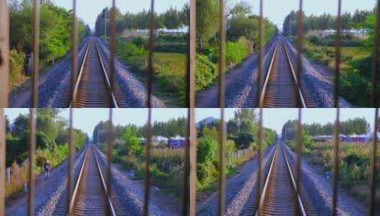 行驶中的火车车尾窗外铁路沿线乡村风景高清在线视频素材下载