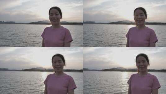 夕阳下中国女性运动后在河边喝水高清在线视频素材下载