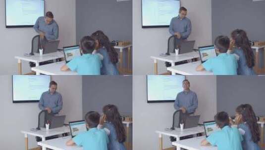 计算机科学老师在课堂上站在办公桌前高清在线视频素材下载