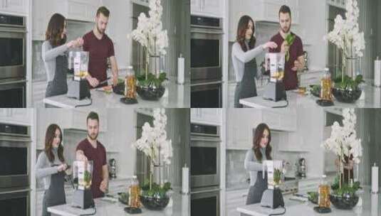 夫妇在家厨房向搅拌机添加配料高清在线视频素材下载