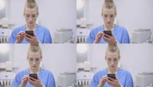 女医生在医疗诊所用智能手机高清在线视频素材下载