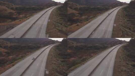 两山之间的高速公路上的车辆高清在线视频素材下载