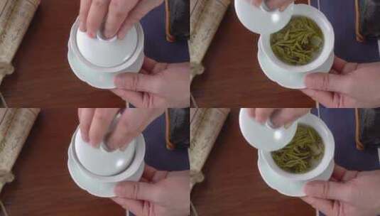 拿起茶碗盖子划拨茶叶绿茶喝茶高清在线视频素材下载