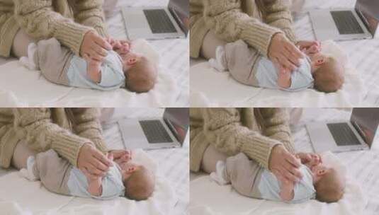 母亲陪床上的婴儿玩耍高清在线视频素材下载